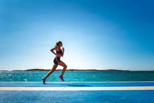 Woman running showing strong leg muscle East Kilbride